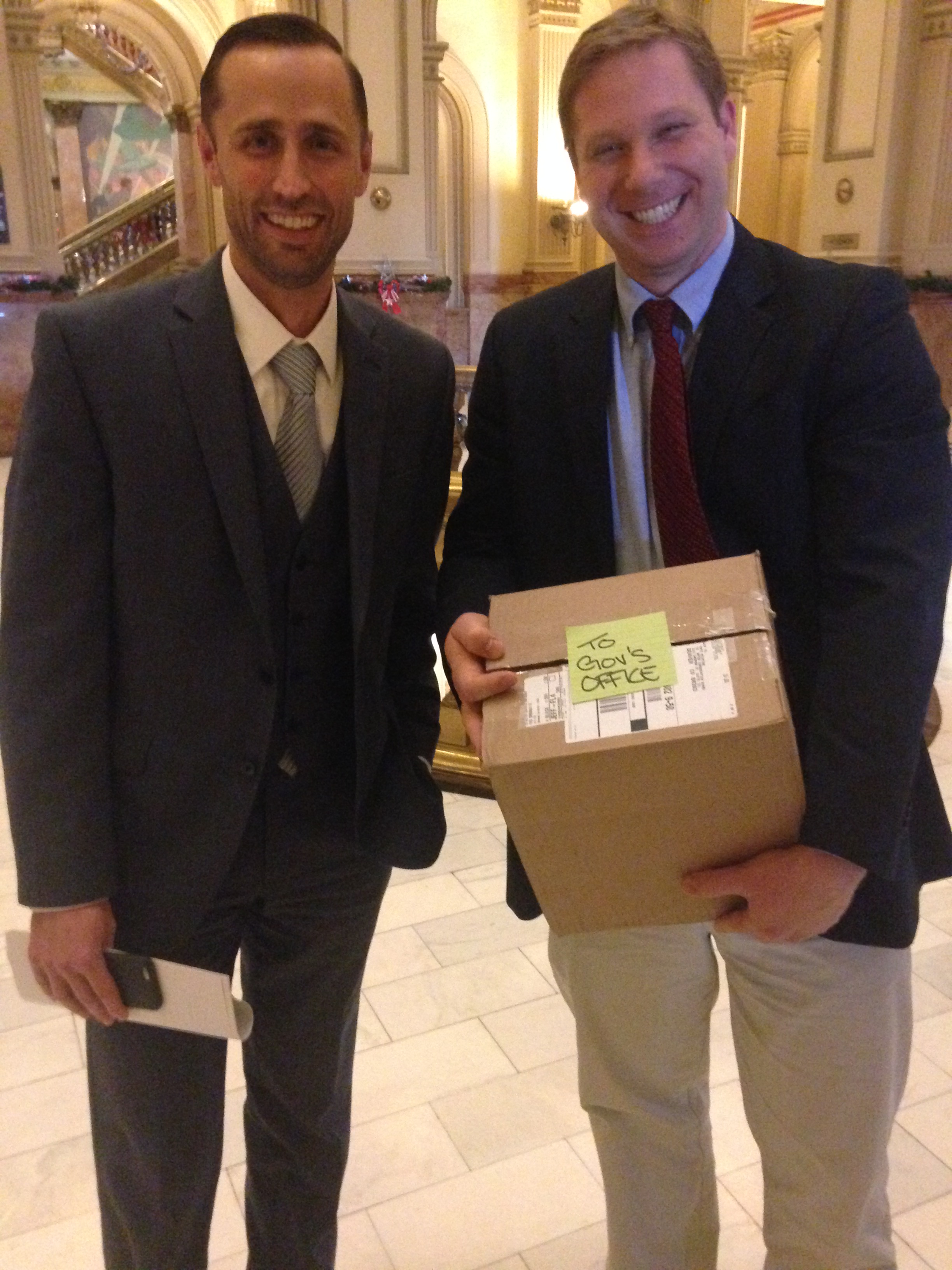 CWCB director James Eklund with manager in Water Supply Planning, Jacob Bornstein bring  a box containing the draft water plan to the Capitol.