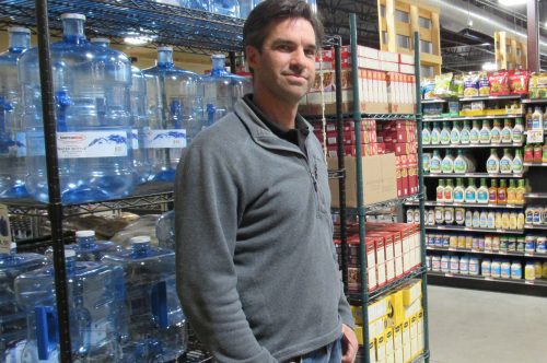 Fresh Farmers Market Manager Amos Lee stands in front of the store's water filling station Nov. 20, 2019. Credit: Jerd Smith